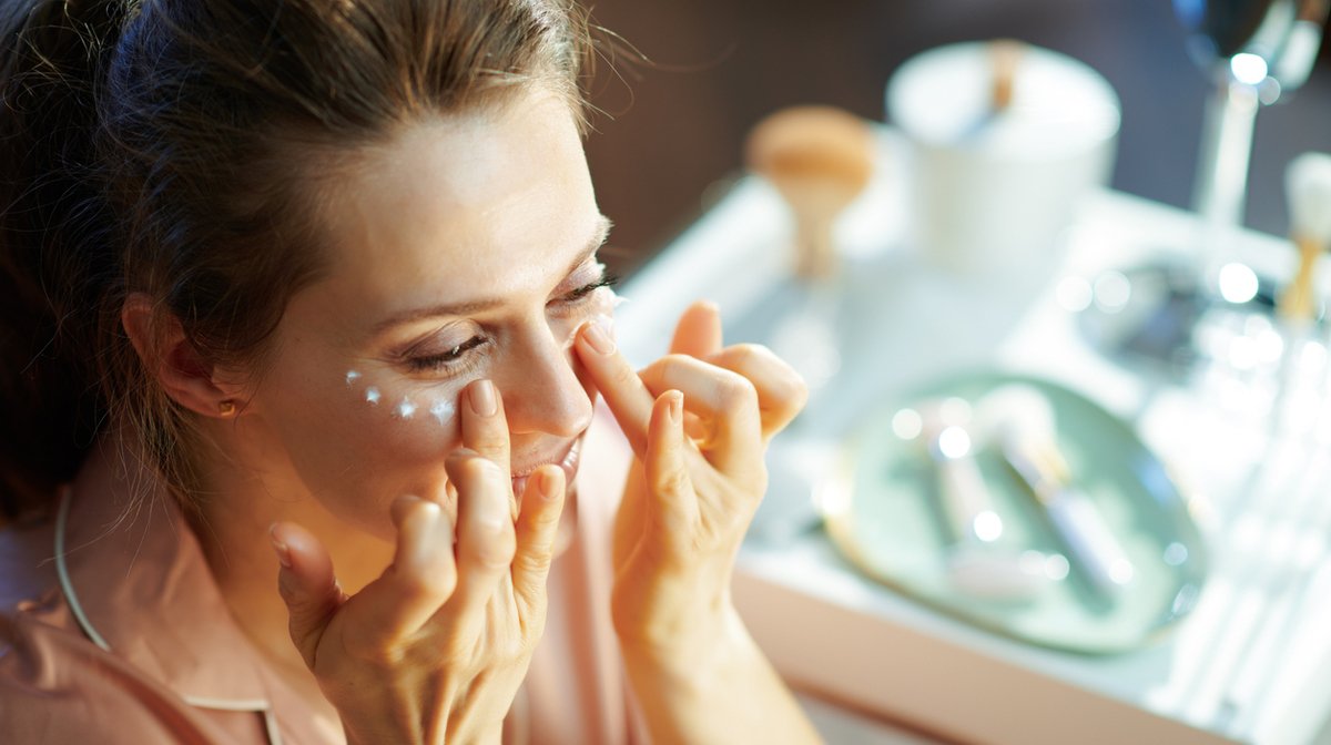 woman learning how to apply eye cream